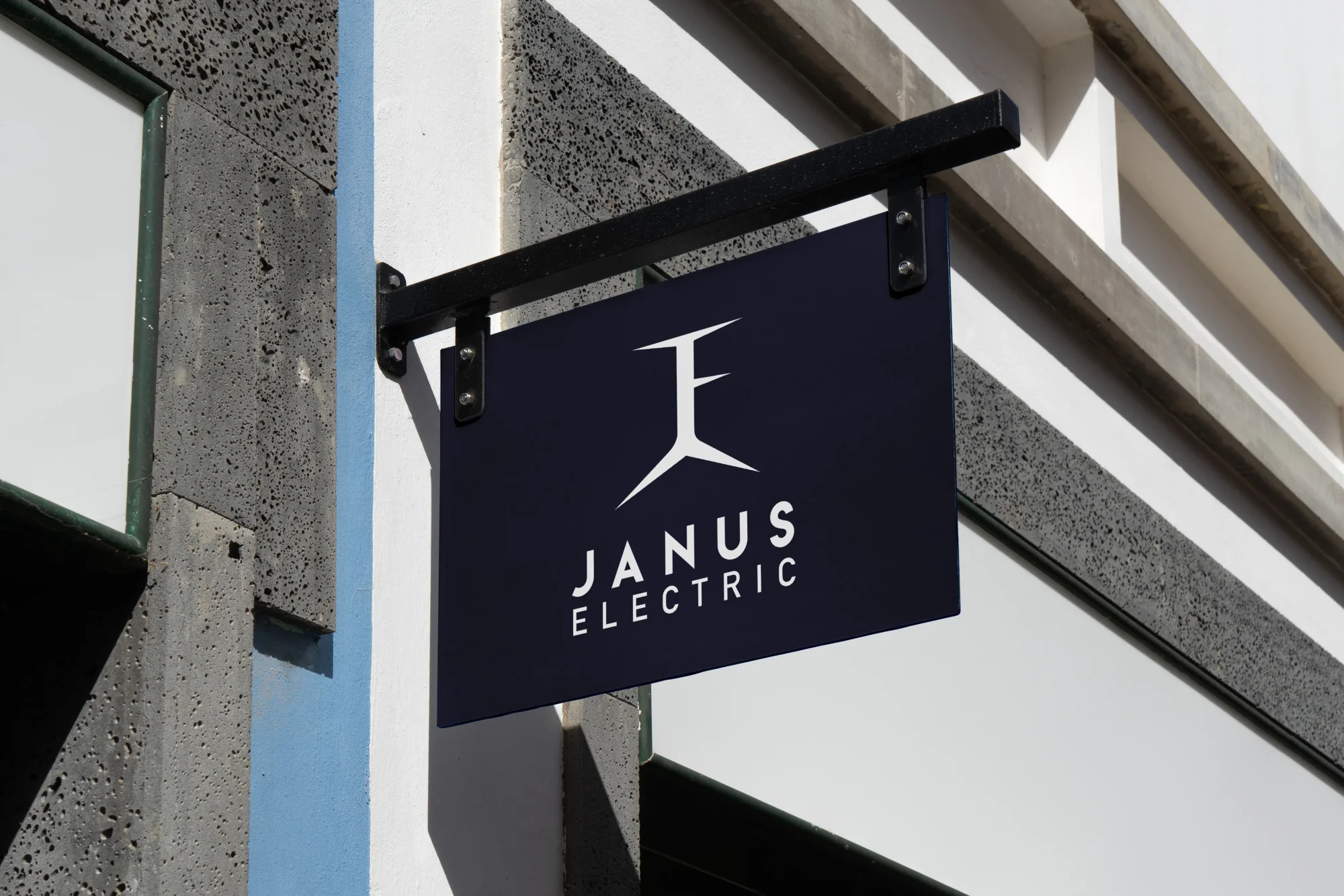 Janus Electric branded hanging shop sign in environment