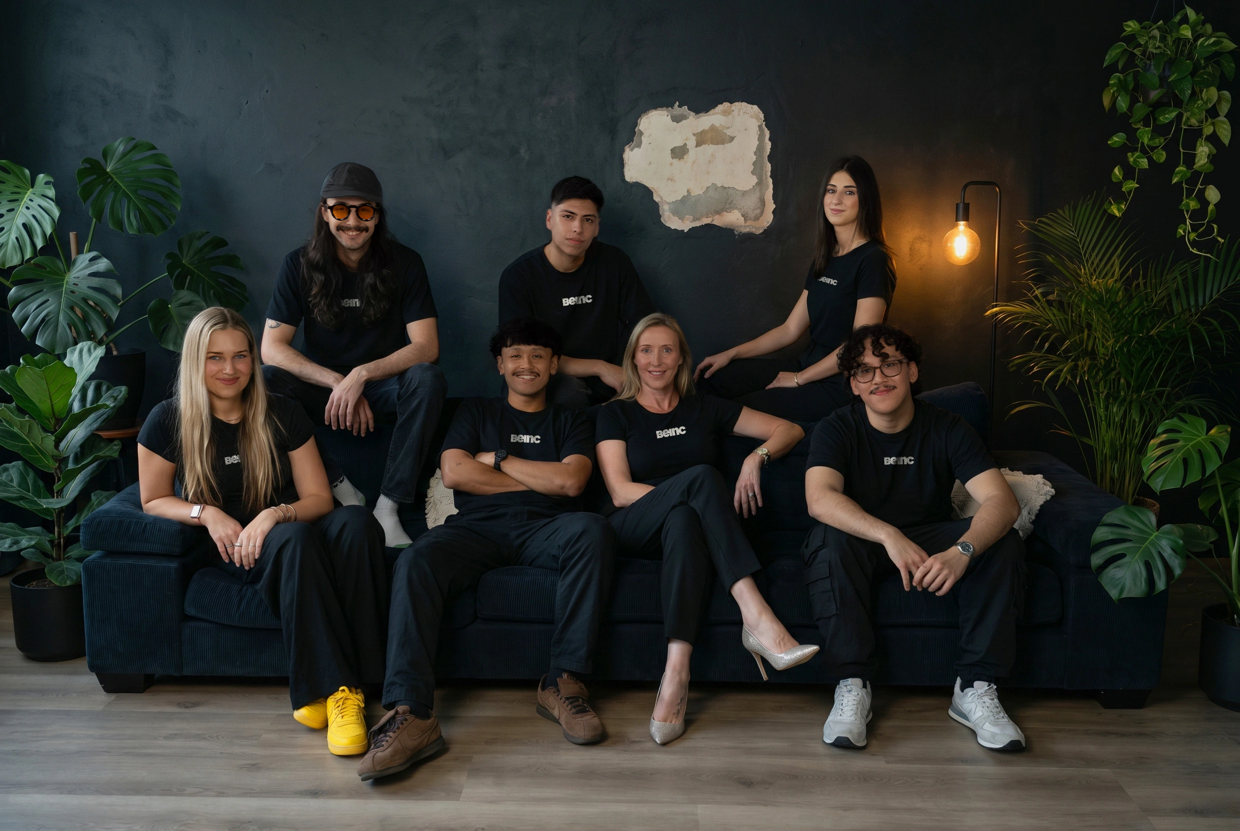 Beinc creative agency team member in black seated on a studio couch
